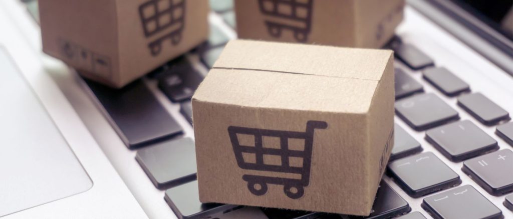 Shopping boxes on laptop representing ecommerce tax