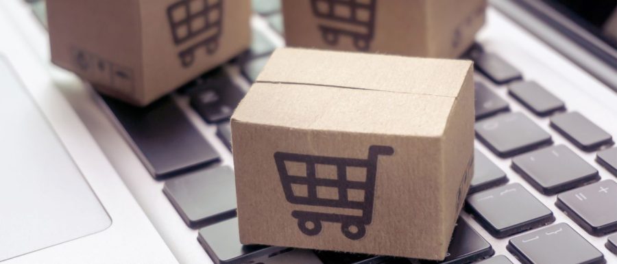 Shopping boxes on laptop representing ecommerce tax